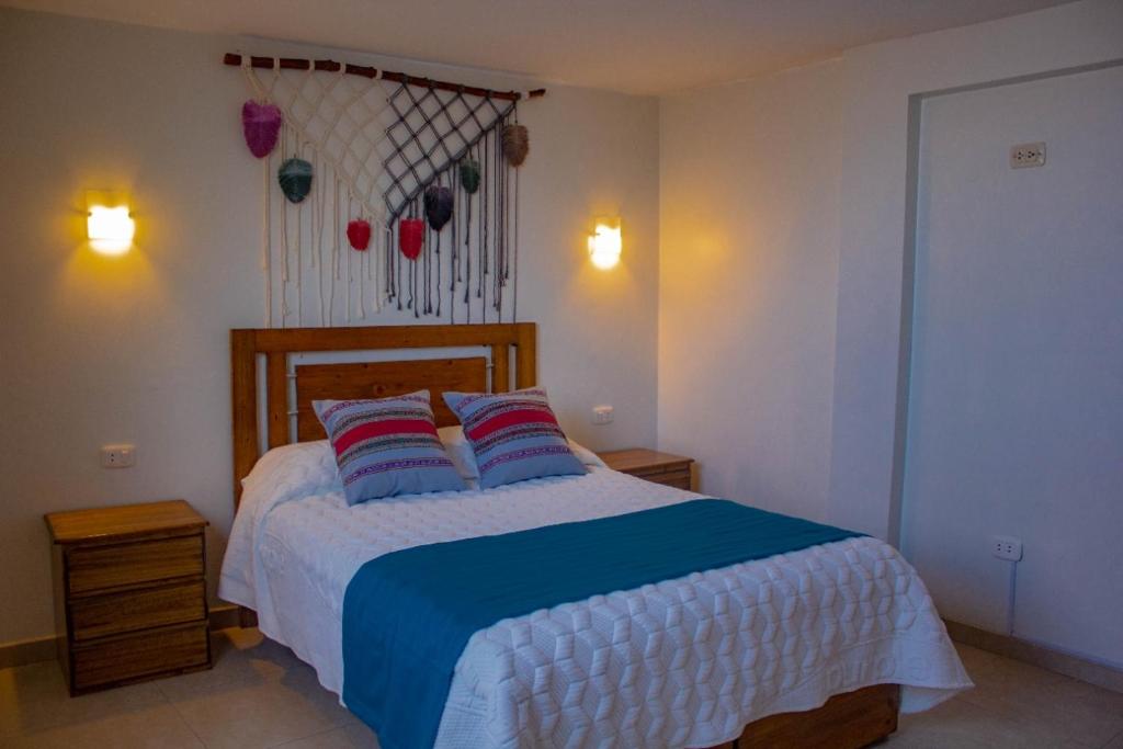 a bedroom with a bed with two pillows on it at Hostal Hatunkay Cajamarca in Cajamarca