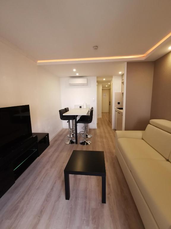 a living room with a couch and a table at Appartement en bord de mer in Cannes