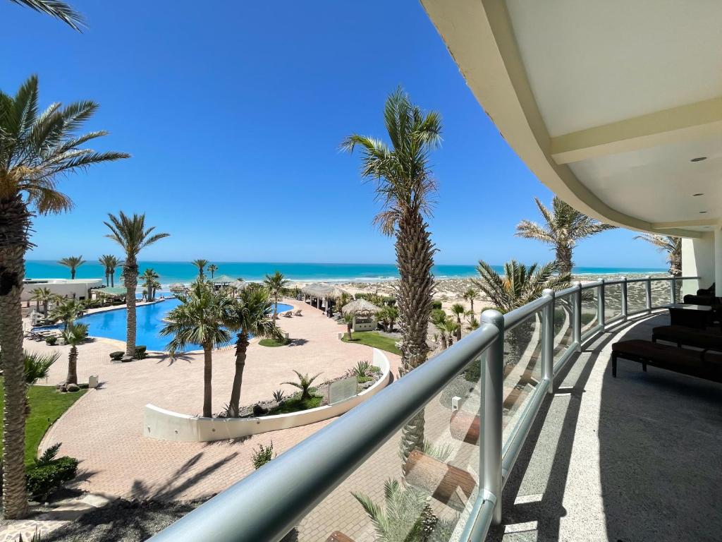 a view of the beach from the balcony of a resort at Upscale Beachfront Condo with Tub and Private Beach in Playa Encanto