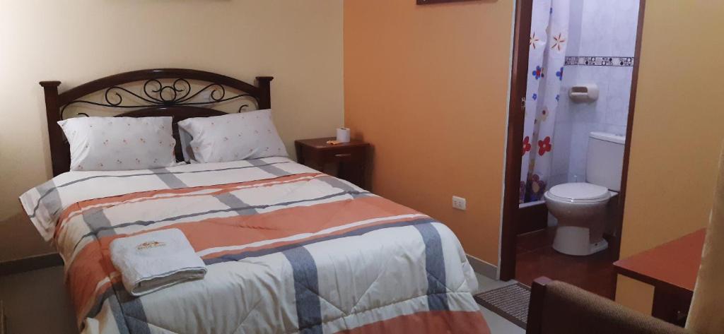 Postel nebo postele na pokoji v ubytování Hostal Capac