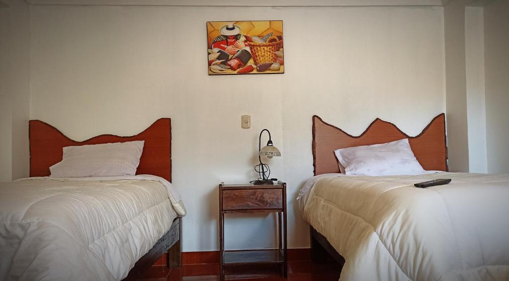 Postel nebo postele na pokoji v ubytování Los Apus Ollantaytambo