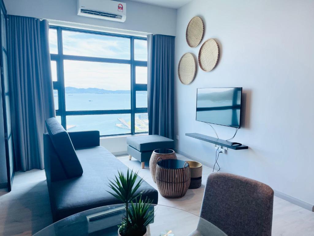 a living room with a view of the ocean at KEEN Suites-Jesselton Quay in Kota Kinabalu