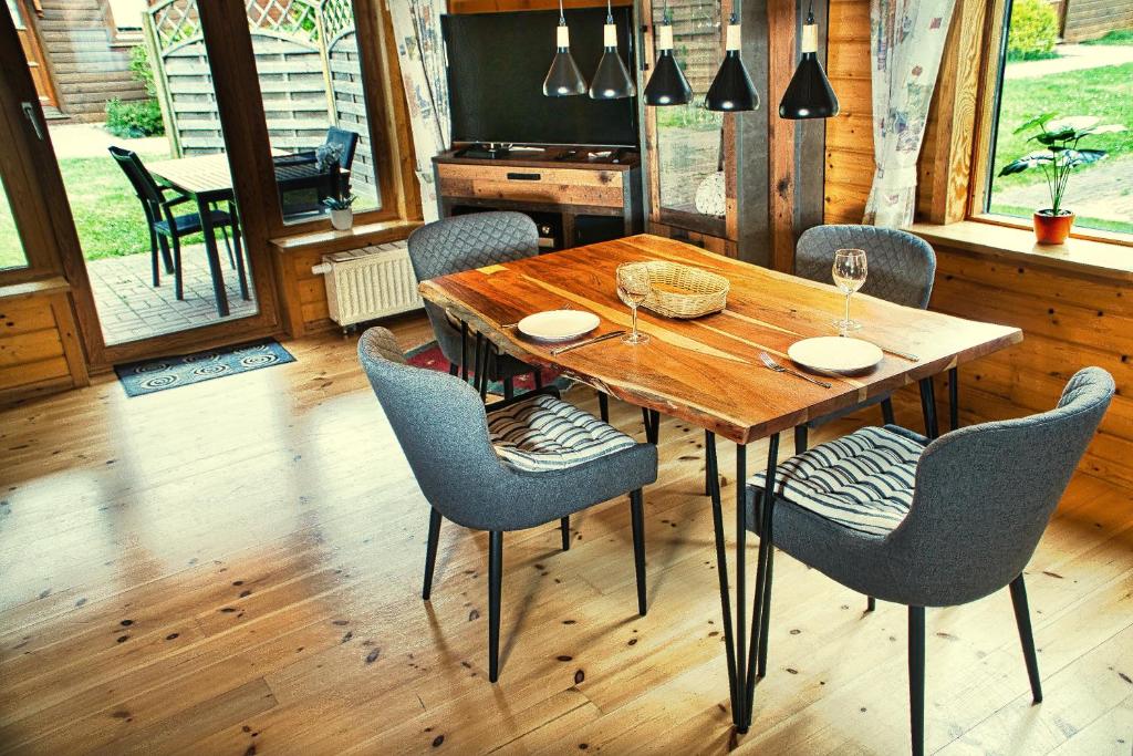 uma sala de jantar com uma mesa de madeira e cadeiras em The house to stay for holidays em Hasselfelde