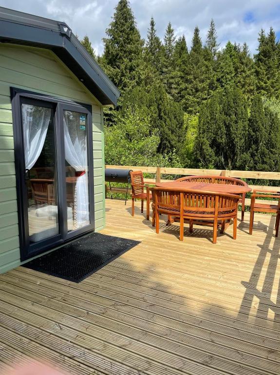 a deck with two benches and a table at The Astoria in Dunoon