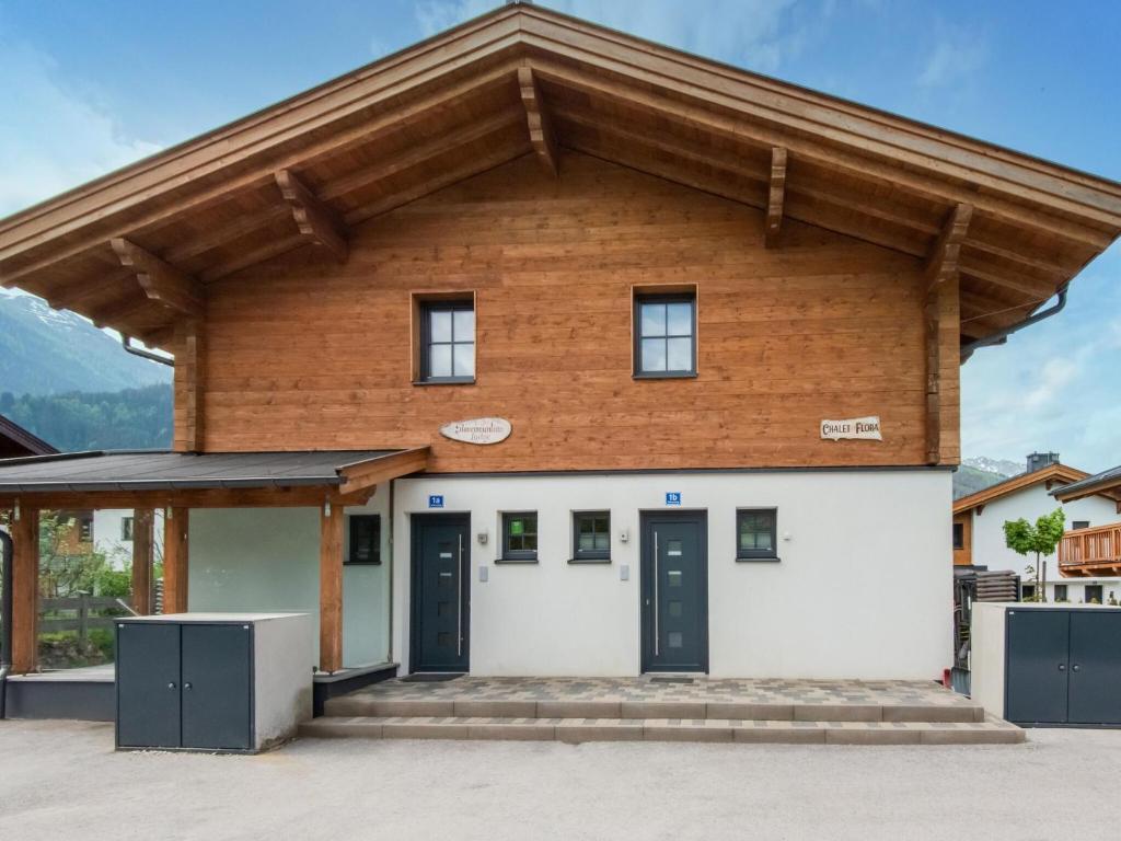 a building with a wooden roof at Lush holiday home in Niedernsill with sauna in Niedernsill