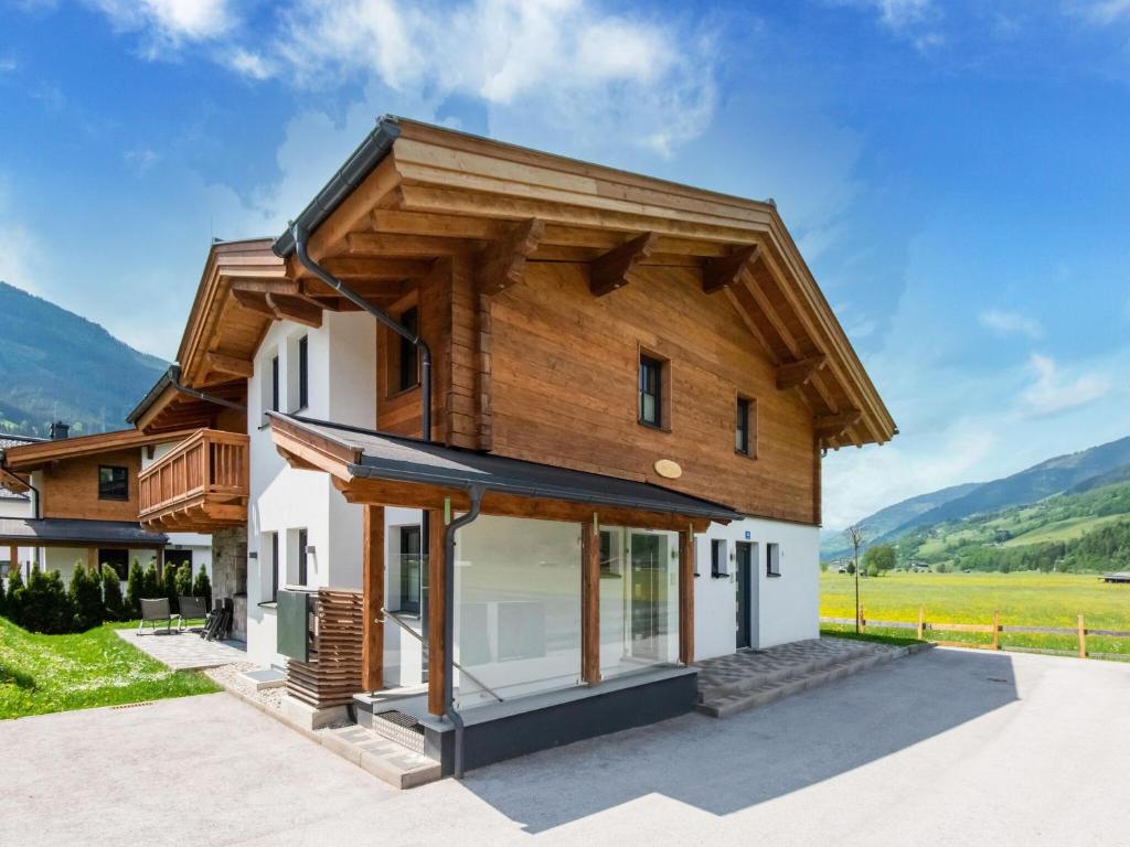 a house with a wooden roof at Luxurious holiday home with sauna in Niedernsill Salzburgerland in Niedernsill