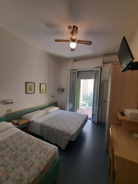 Postel nebo postele na pokoji v ubytování Hotel Erika