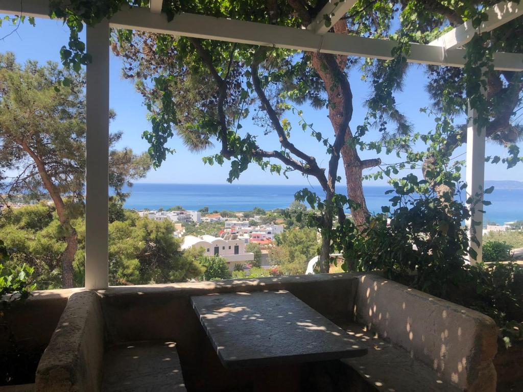 a view of the ocean from a pergola at Karpathios Studios Pefkos in Pefki