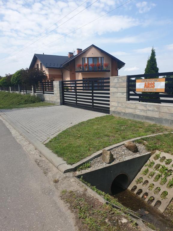 a house with a drain in front of it at Aris Pokoje Gościnne in Wojnicz