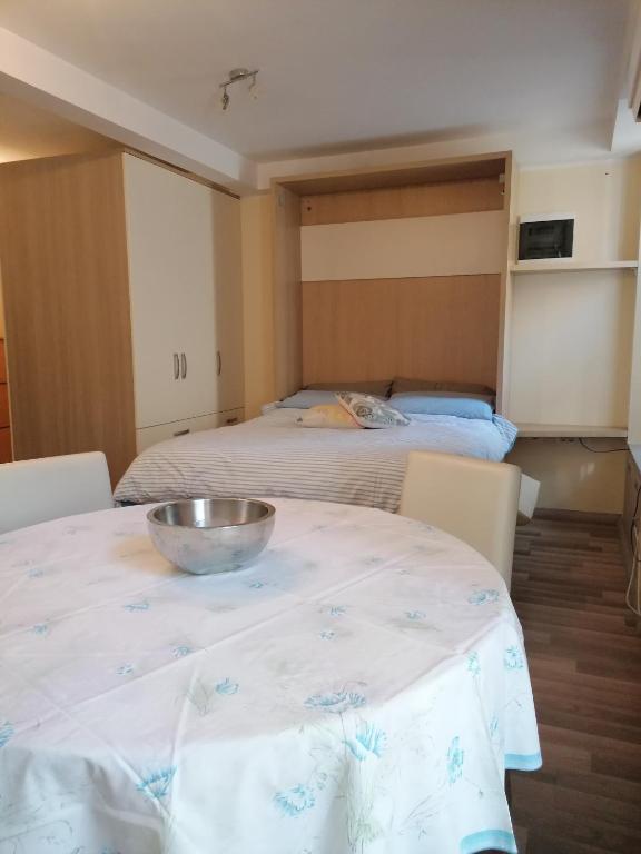 un bol en una mesa en una habitación con 2 camas en Apartma Olivieri en Koper