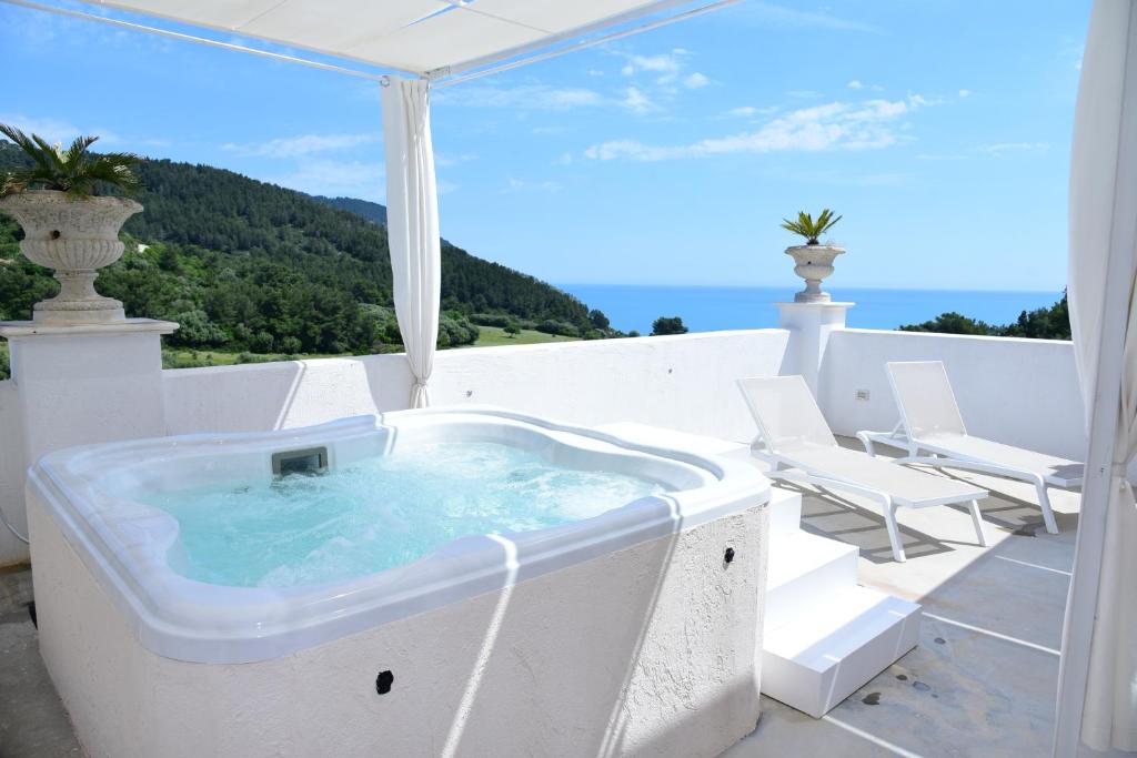 a jacuzzi tub on a balcony with a view at HMO Glamping & Suites in Vignanotica in Mattinata