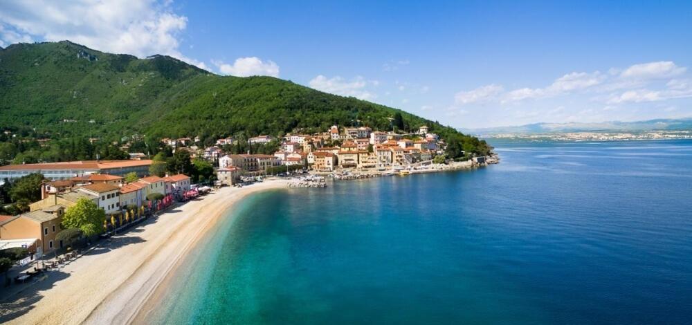 an aerial view of a town on a beach in the water at BISER KVARNERA 1. in Mošćenička Draga