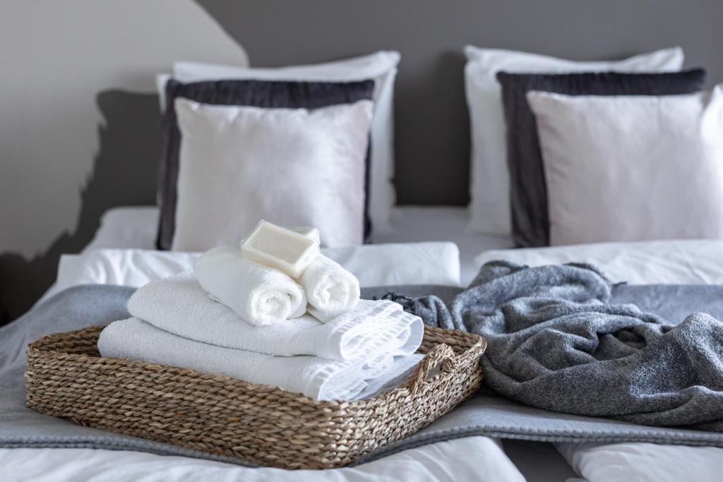 a basket of towels and towels on a bed at Arctic Railway City Suite in Rovaniemi