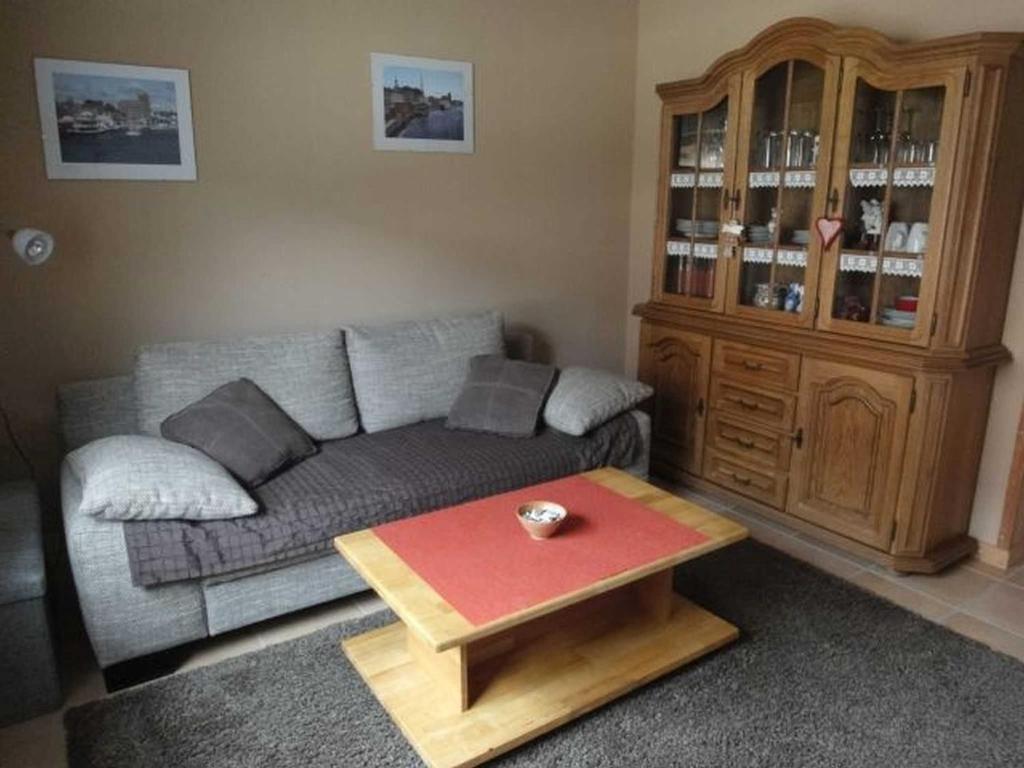 a living room with a couch and a coffee table at Ferienwohnung Hilde Schneider in Kappeln