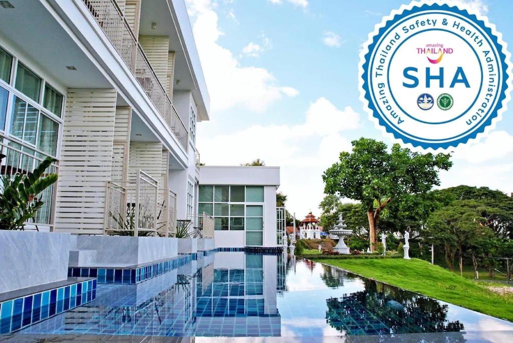 a sign in front of a building with a pool at Pua De View Boutique Resort in Pua