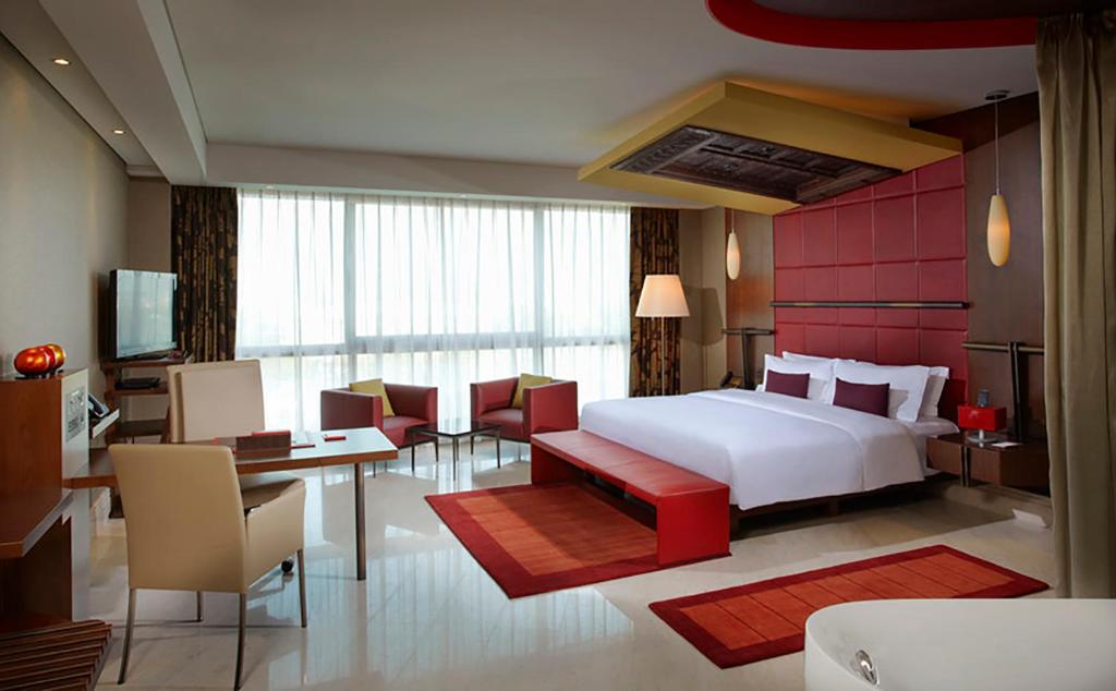 a hotel room with a large bed and a large window at Jumeirah Creekside Hotel in Dubai