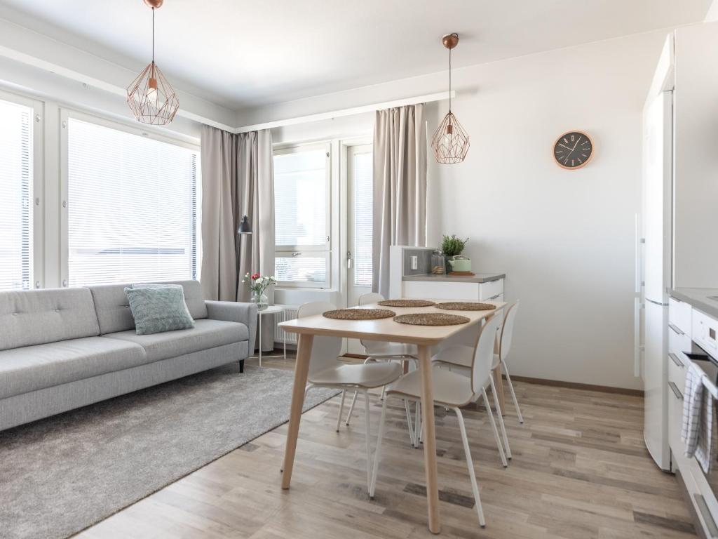 a living room with a table and a couch at Arctic Penthouse City Suite in Rovaniemi