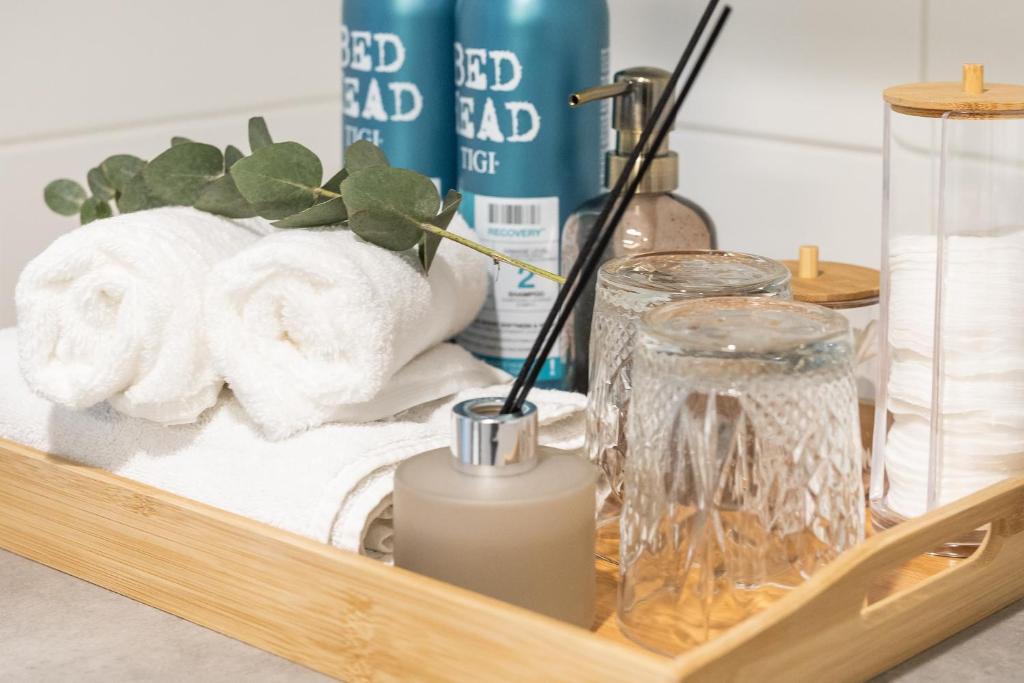 a tray with towels and a candle on a table at Arctic Penthouse City Suite in Rovaniemi
