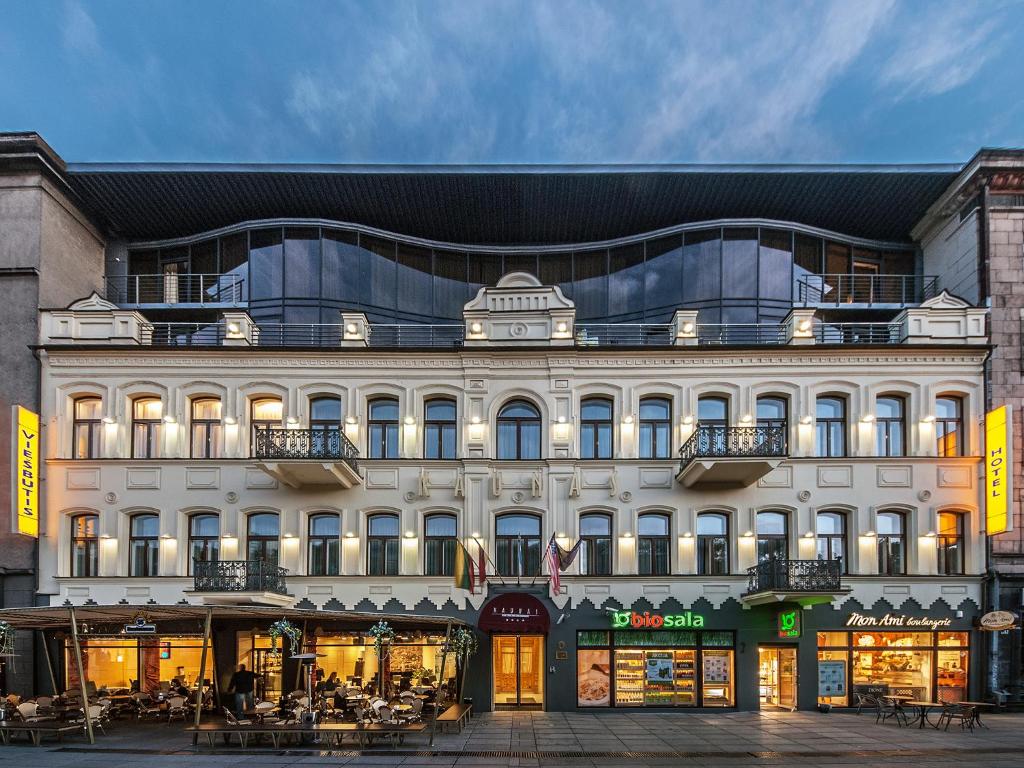 un gran edificio blanco con mesas delante en Kaunas en Kaunas