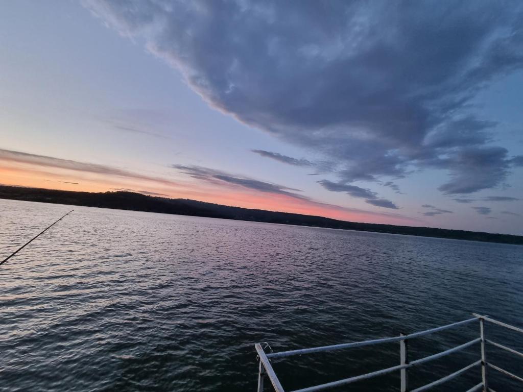 a boat in the water at sunset at La Ponton AdaKale in Vrancea