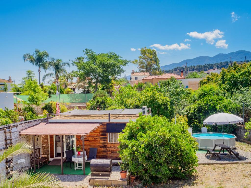 a log house with a pool and a yard at Cubo's Estudio El Encanto de Coín in Coín