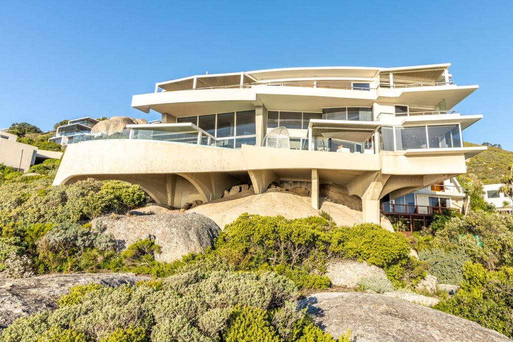 a house on top of a hill with rocks at The Marvel Beach House in Cape Town