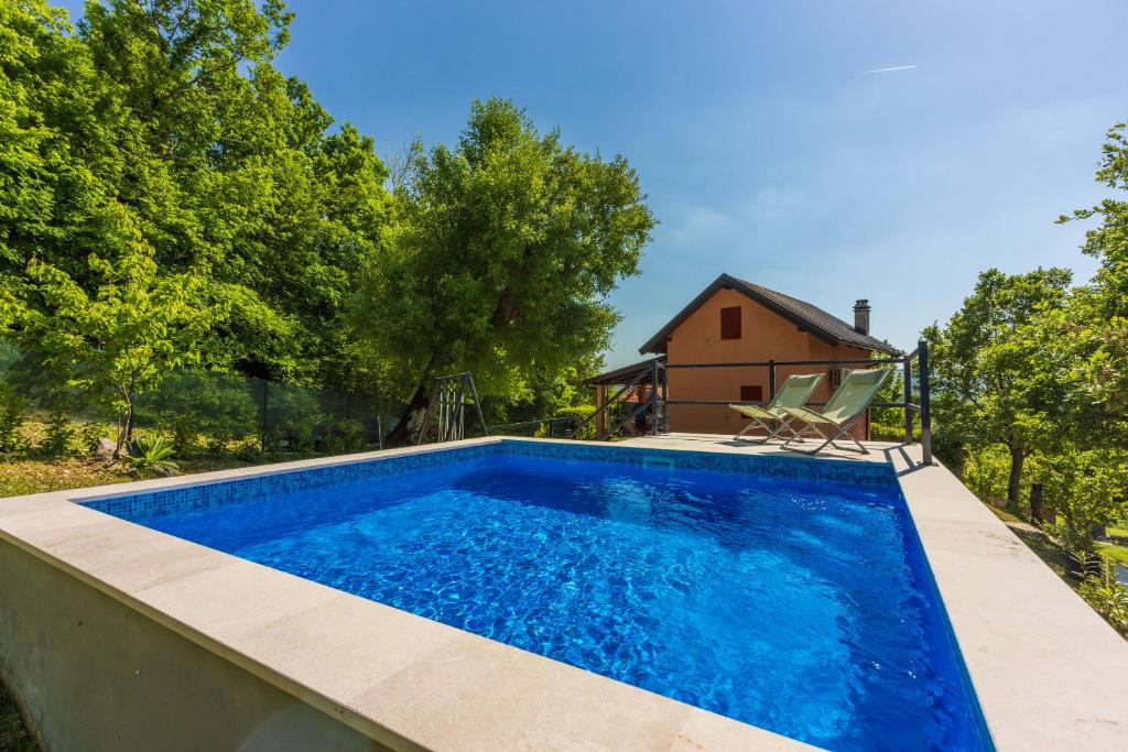 a swimming pool in front of a house at House Nado in Pulgarija Čepić
