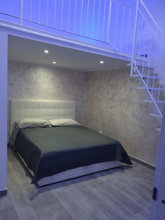 a bedroom with a bed and a staircase at La Perla di Ele in Bari