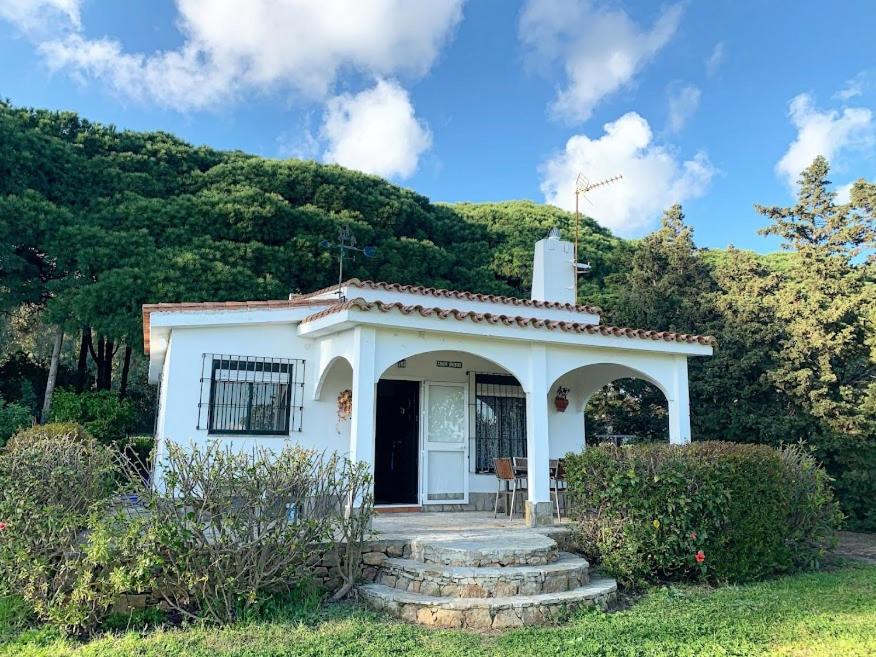 a small white house in front of a mountain at Finca Dos Vientos Tarifa in Tarifa