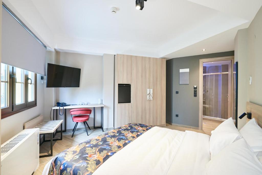 Postel nebo postele na pokoji v ubytování The Mavili urban stay