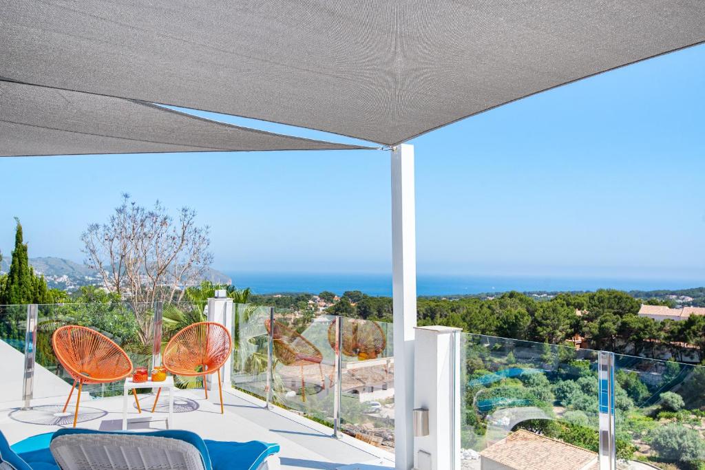 モライラにあるVilla Momily - Dream Seaview - by Holiday Rentals Villamarの海の景色を望むバルコニー(椅子付)