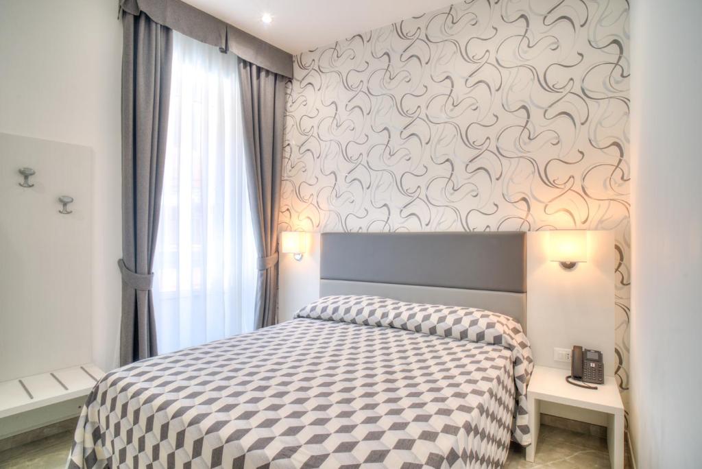 Postel nebo postele na pokoji v ubytování Hotel Porto Di Roma