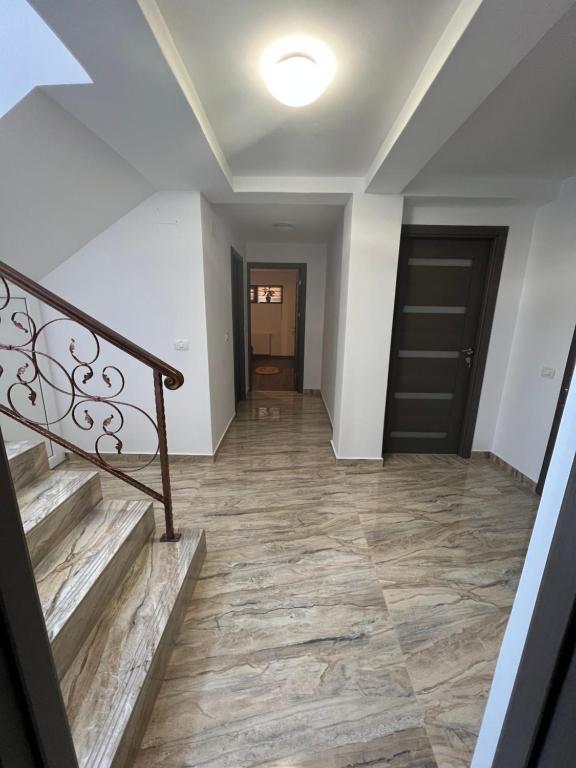 a hallway of a house with stairs and a door at Vila Dan in Galaţi