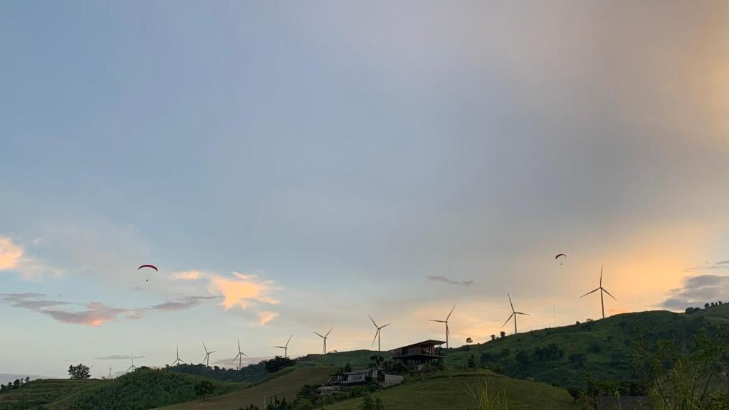 a group of wind turbines on top of a hill at Likit Kirin Khao Kho in Phetchabun