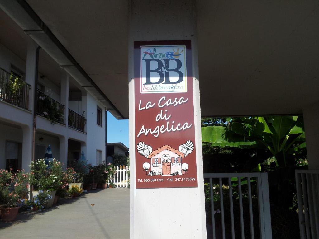 a sign for a bbq in front of a building at B&B La Casa di Angelica in Roseto degli Abruzzi