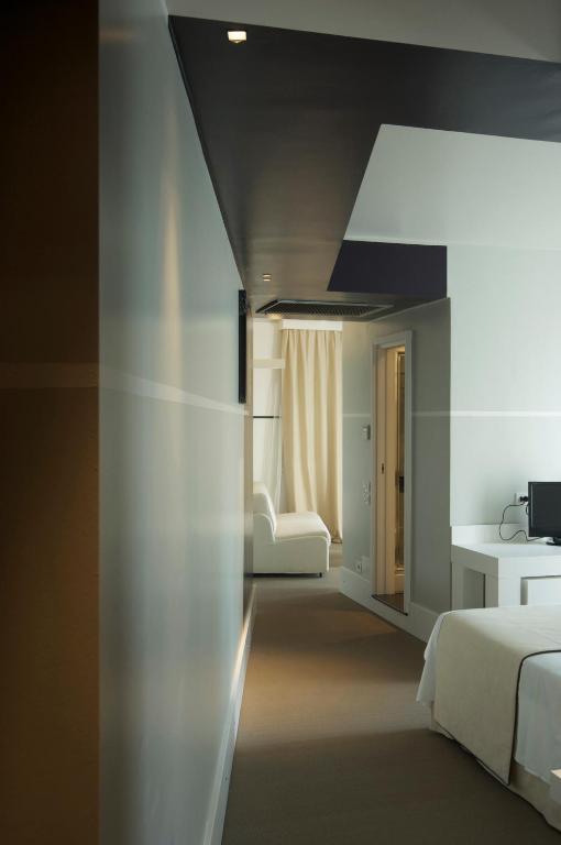 a bedroom with two beds and a black ceiling at Hotel Piccolo Portofino in Portofino