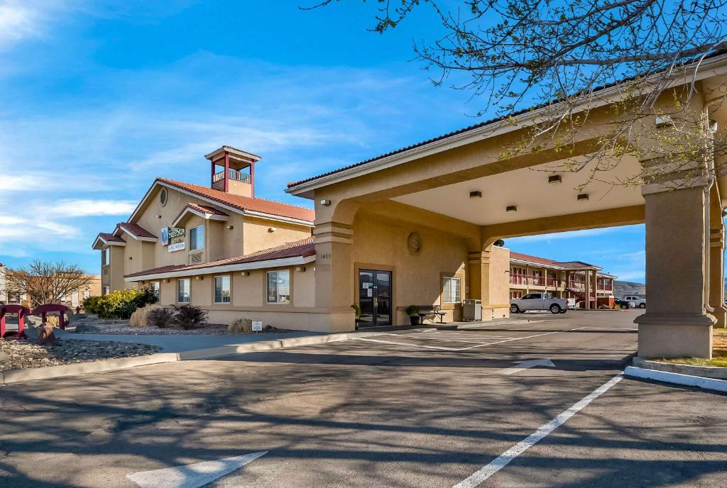 a front view of a building with a parking lot at SureStay Hotel by Best Western Fernley in Fernley