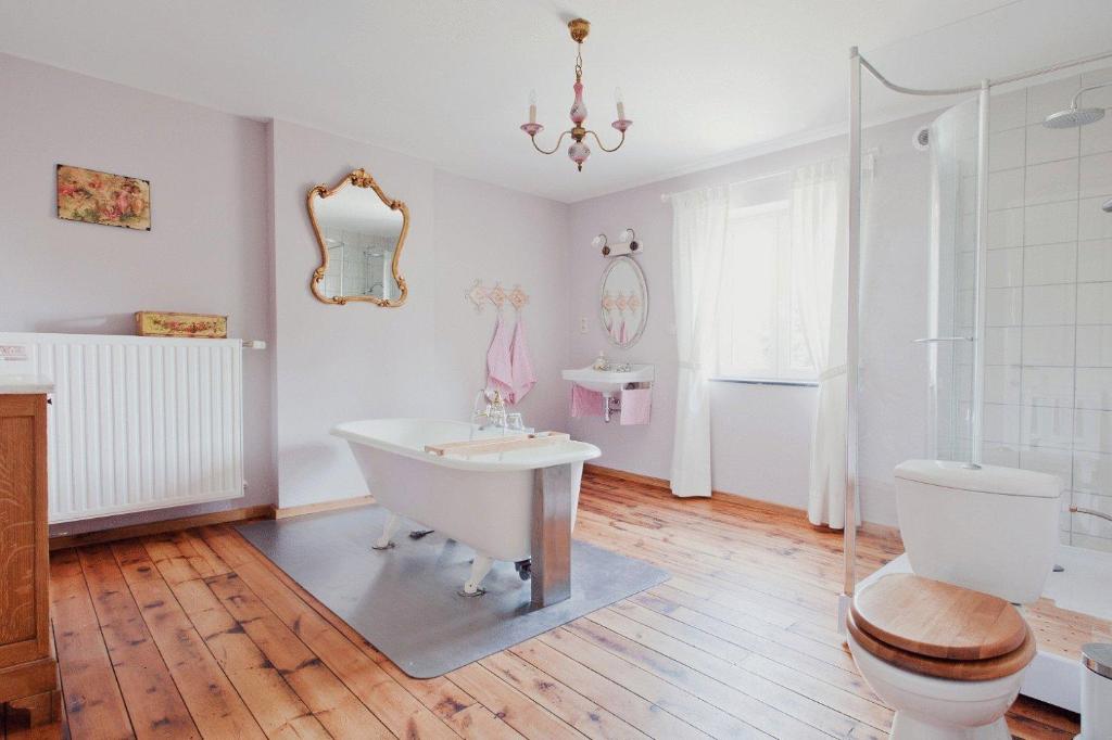 La salle de bains est pourvue d'une baignoire, de toilettes et d'un lavabo. dans l'établissement Vakantiewoning Tivoli, à Dilsen-Stokkem