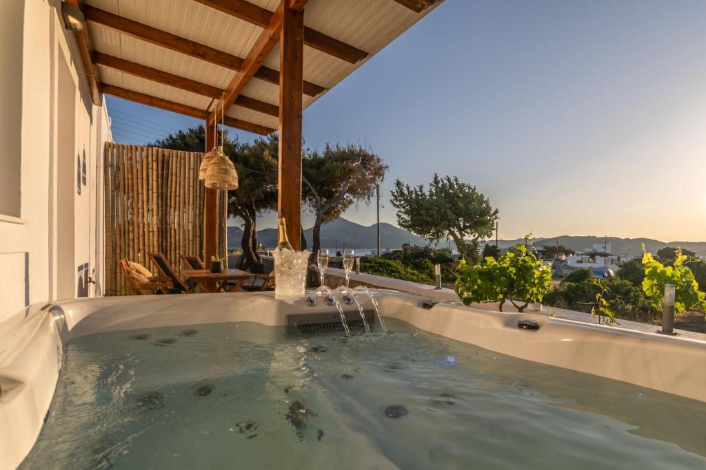 a hot tub in the backyard of a house at Kallia's Suites Milos in Adamas