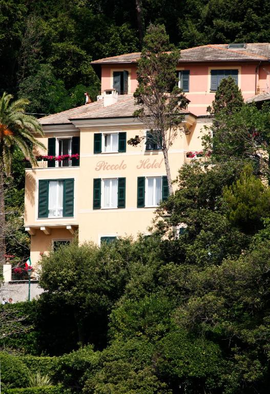 a building on a hill with trees at Hotel Piccolo Portofino in Portofino