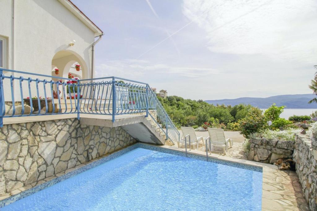 a villa with a swimming pool and a balcony at Villa Paradiso in Plomin - Istrien in Plomin