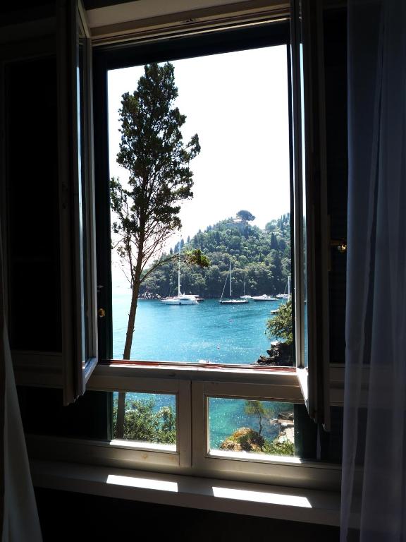 a window with a view of a body of water at Hotel Piccolo Portofino in Portofino