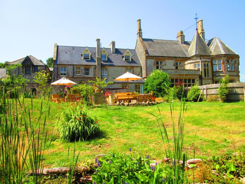 a large house with a lawn in front of it at Weston Manor in Freshwater