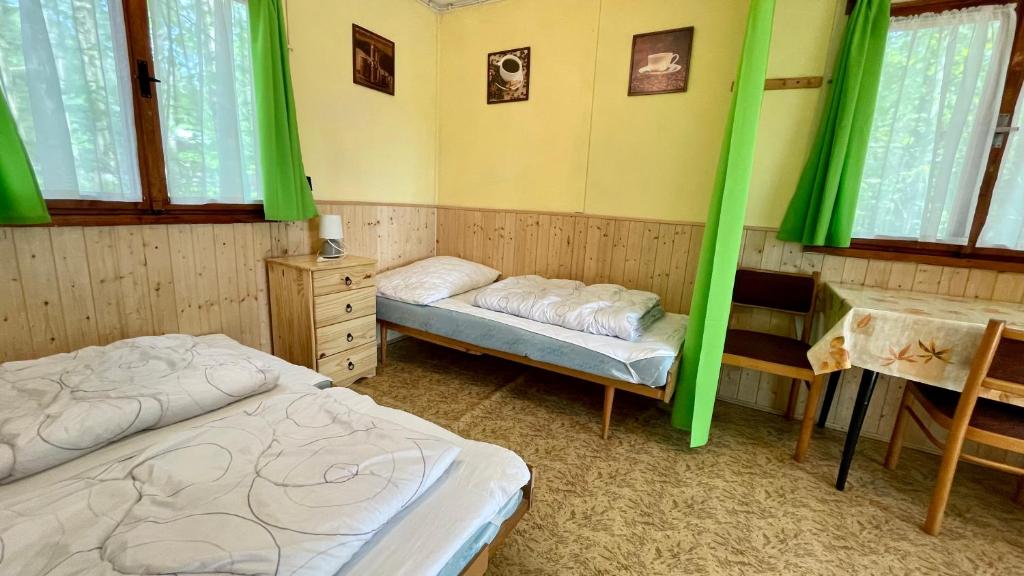 Postel nebo postele na pokoji v ubytování Chatový areál ATLAS