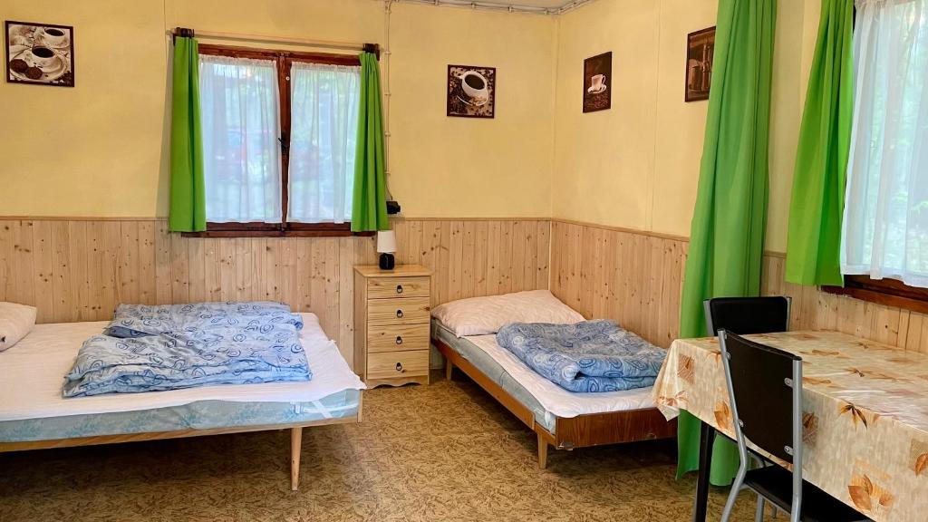 Postel nebo postele na pokoji v ubytování Chatový areál ATLAS