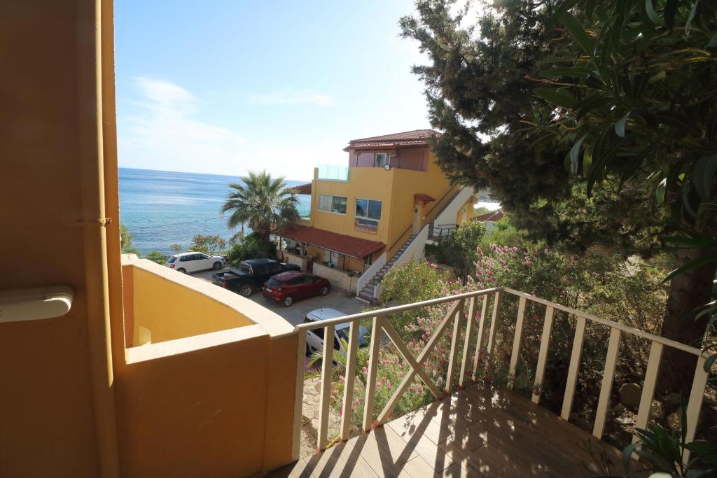 a balcony of a house with a view of the ocean at Horizon Beach Hotel in Plakias