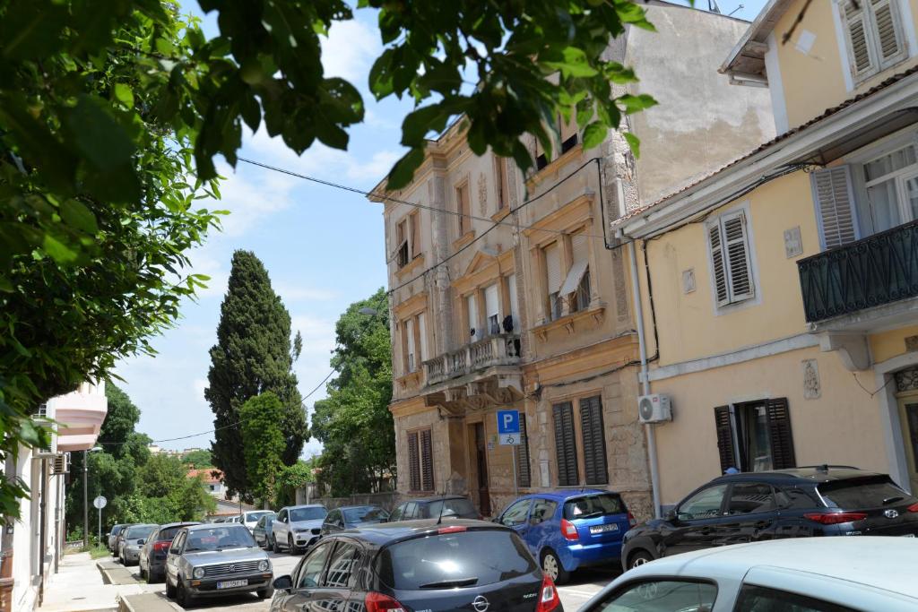 a city street with cars parked on the street at Apartment Boris 2161 in Pula