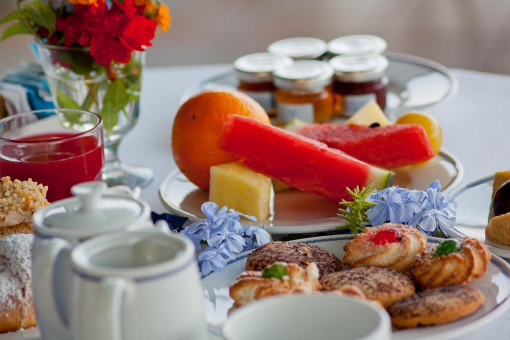 a plate of food with pastries and jams on a table at Sorriso Thermae Resort & Spa in Ischia