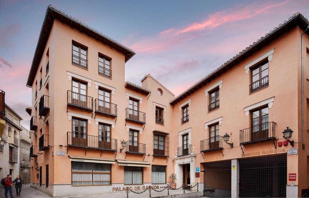a group of buildings in a street with a sky at Sercotel Palacio de los Gamboa in Granada