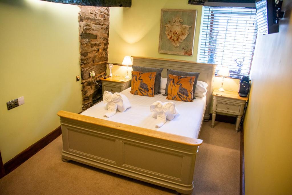 a bedroom with a bed with towels on it at The Sun Boutique and Lounge in Hawkshead